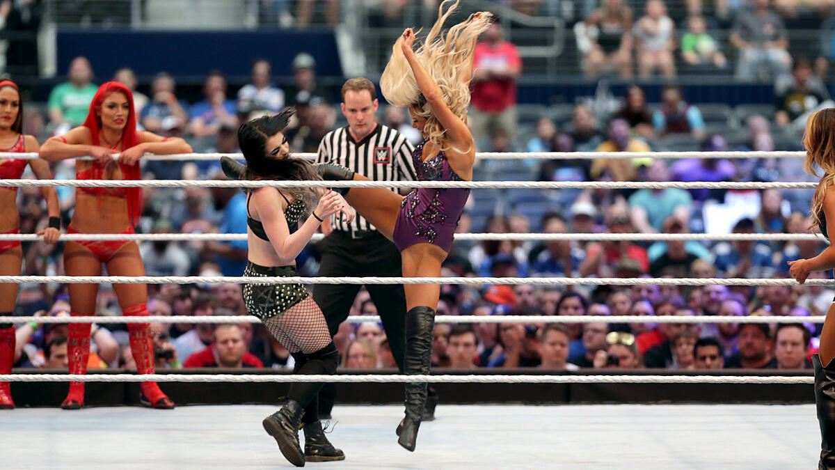 Lana knocks Paige to the mat repeatedly with roundhouse kicks during her in-ring debut.