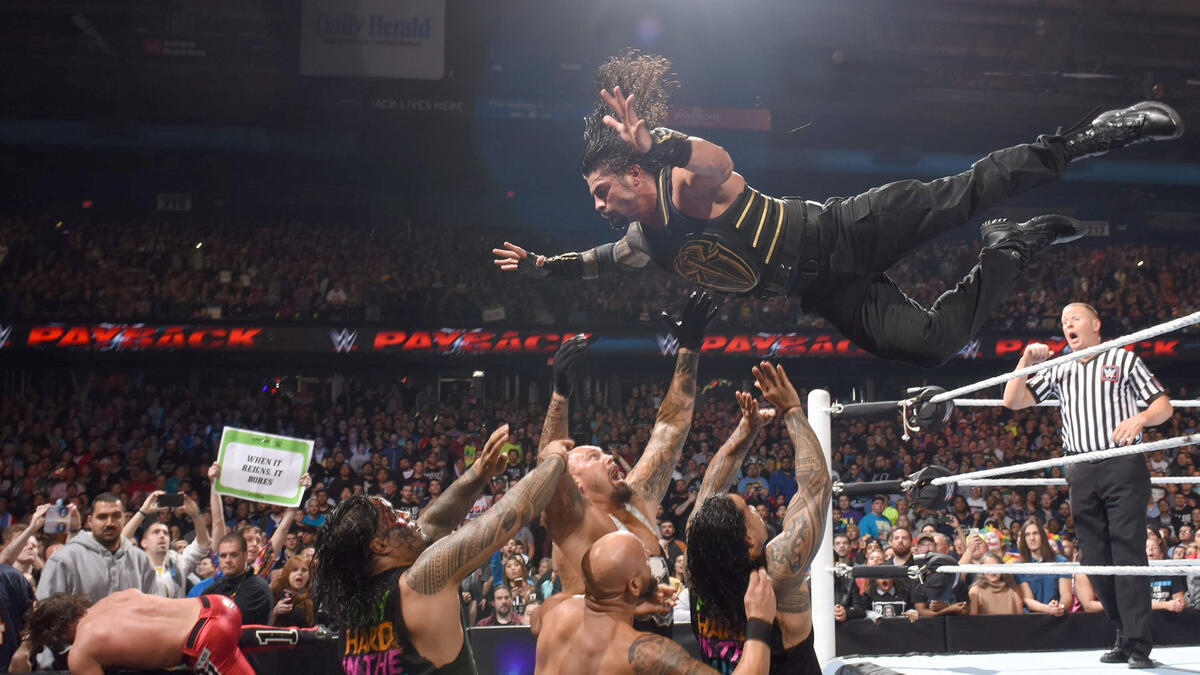 Reigns takes nearly everyone out with a dive over the ropes.