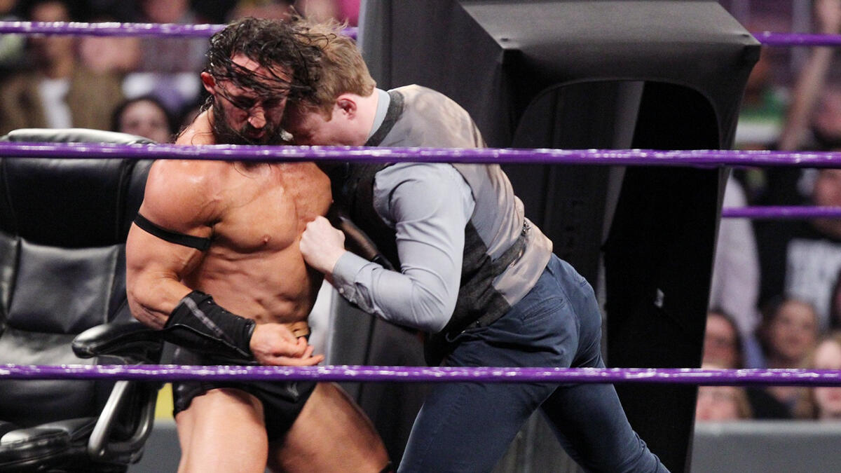 A brutal headbutt sends Neville flying from the ring.