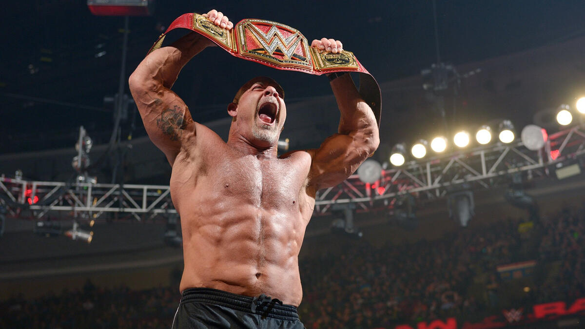 Goldberg celebrates with the Universal Championship after dropping Lesnar.