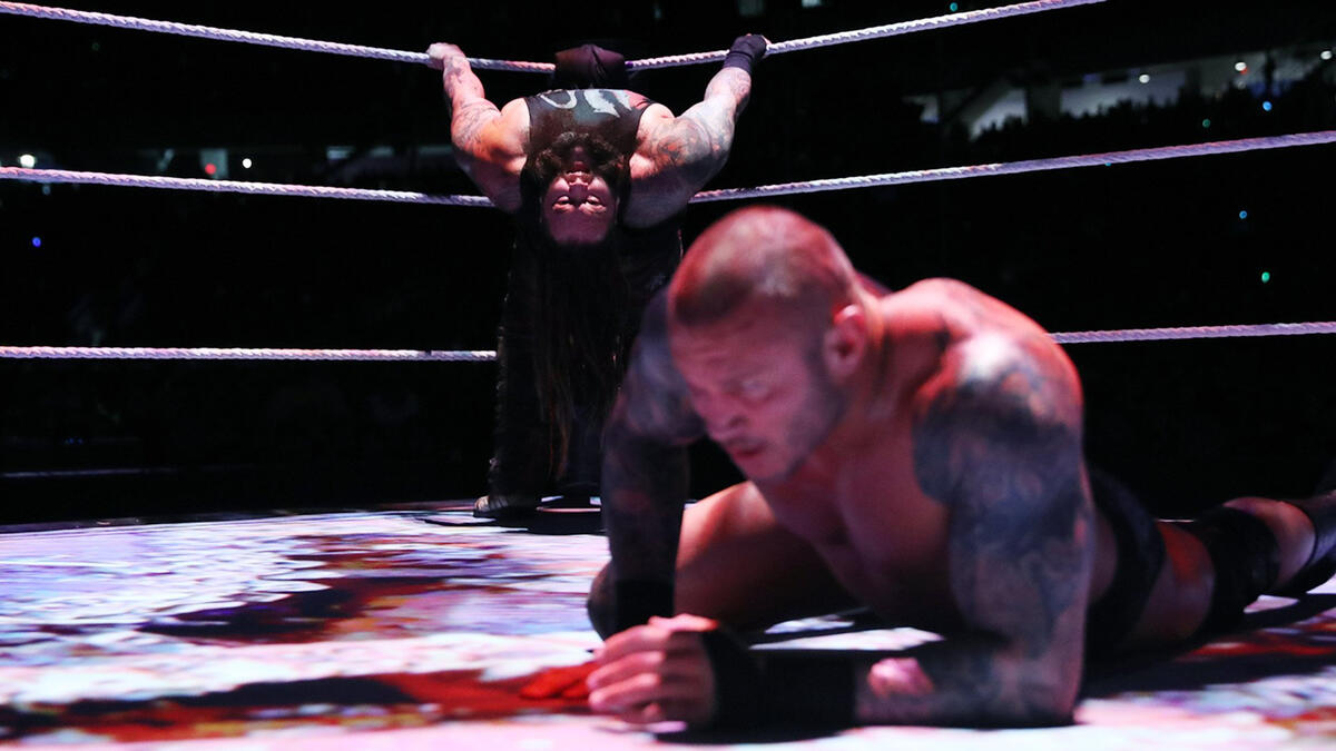 Wyatt distracts Orton with disturbing images on the ring canvas.