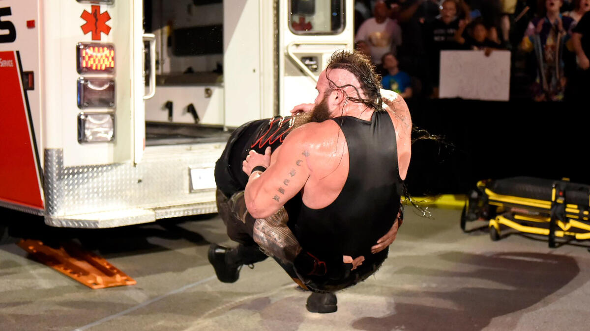 But Reigns reemerges from the ambulance and takes down Strowman with a Spear!