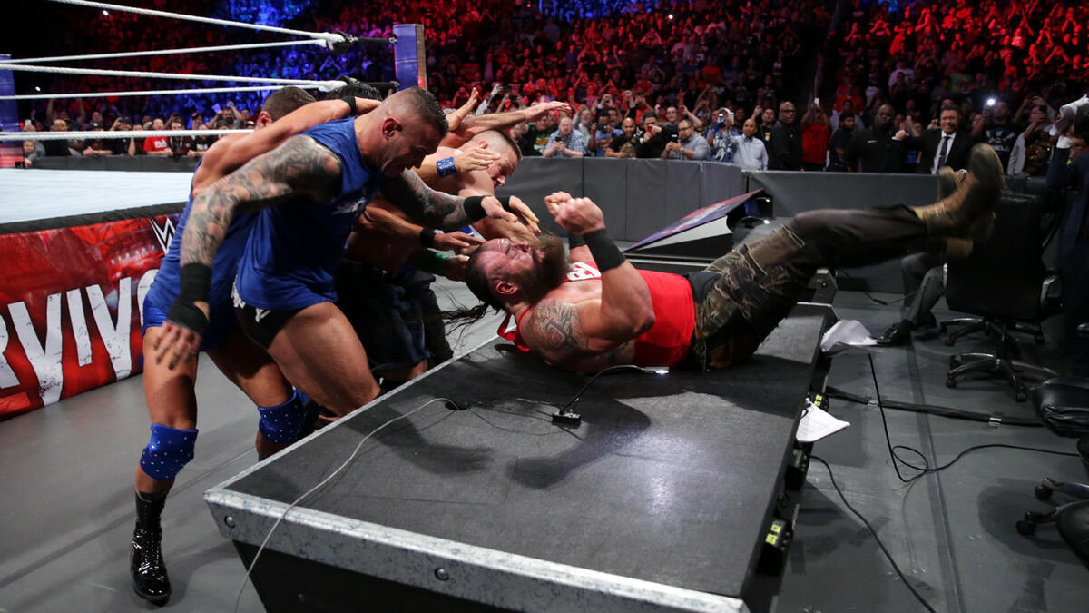 Team SmackDown joins forces to slam The Monster Among Men through a table.
