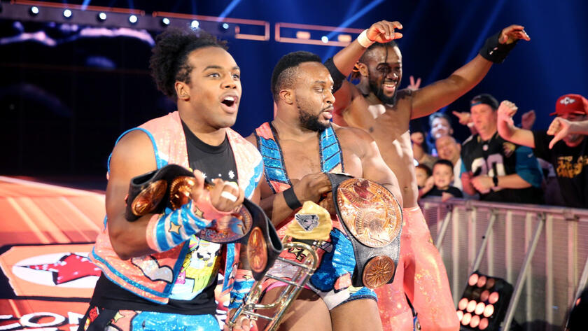 Xavier Woods, Big E and Kingston celebrate their successful title defense.