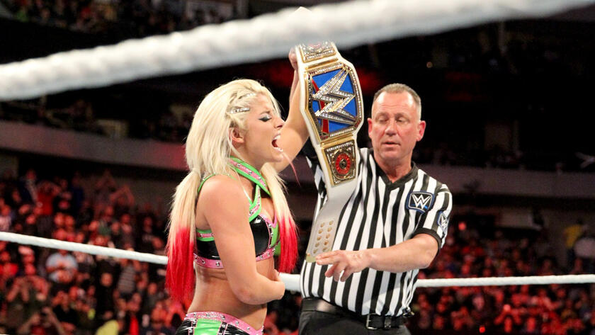Bliss raises the SmackDown Wormen's Title in a flurry of emotion.