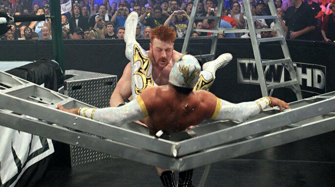 The crowd inside Chicago's Allstate Arena gasps as Sin Cara's body nearly breaks the ladder in half.  