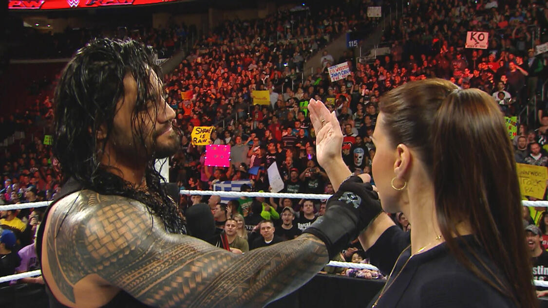 Roman Reigns catches the arm of Stephanie McMahon on Monday Night RAW 