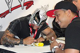 Rey Mysterio signs an autograph at Comic-Con International 2011