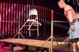John Cena prepares to dump dozens of chairs on top of Wade Barrett