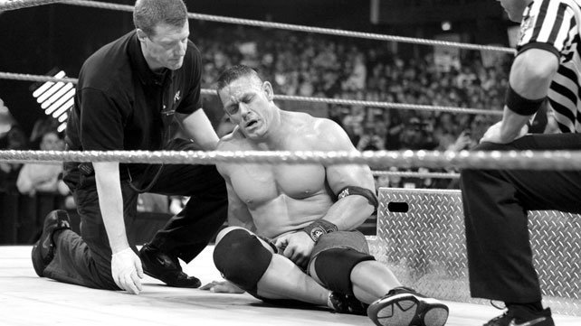 John Cena is tended to by medical technicians after his Extreme Rules Match with Brock Lesnar