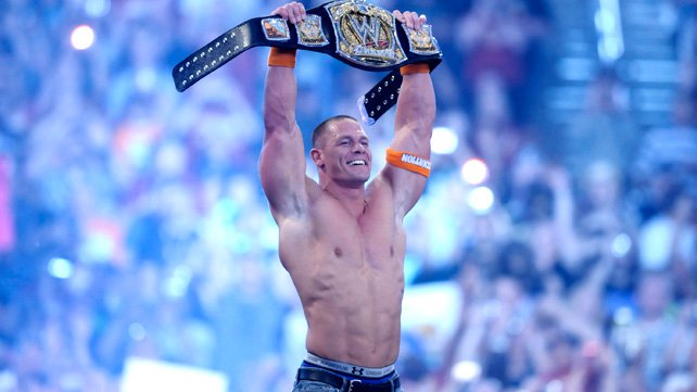 A jubilant John Cena celebrates winning the WWE Championship at WrestleMania XXVI.