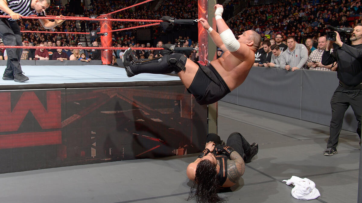 Samoa Joe launches himself onto Roman Reigns (Picture: WWE)