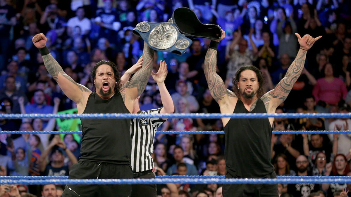 The Usos celebrate after claiming the titles from their longstanding rivals.