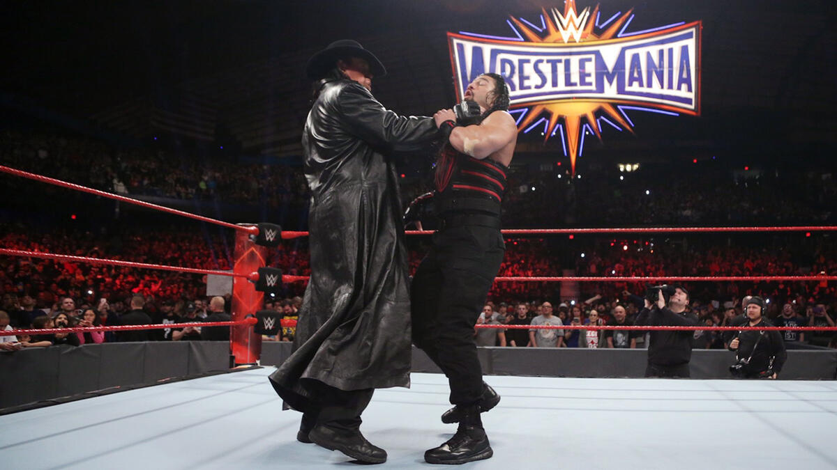 Undertaker chokeslams Roman Reigns (Picture: WWE)