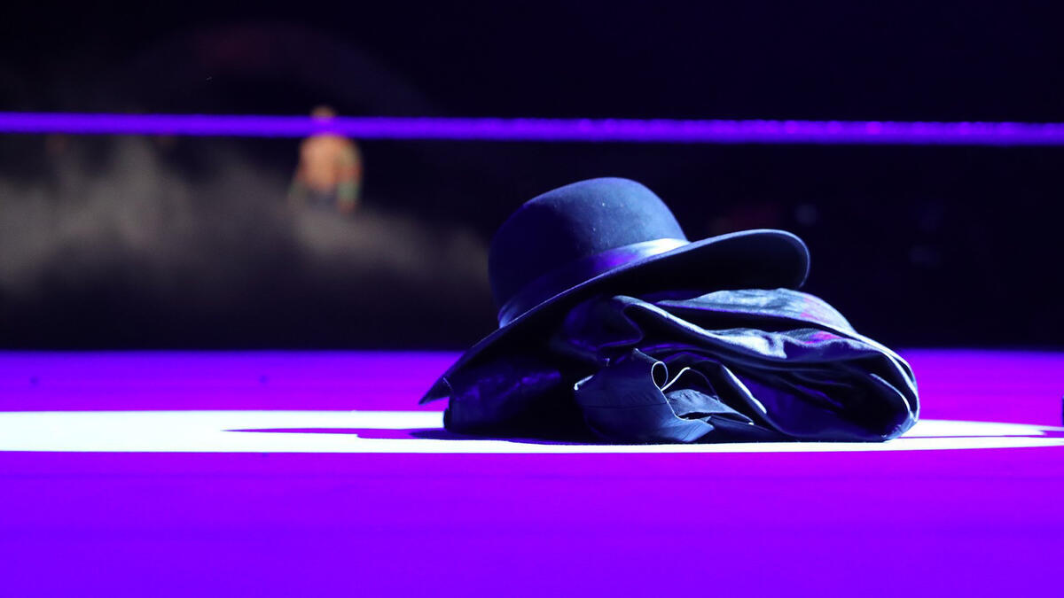 Suddenly, The Undertaker's hat and jacket appear in the ring.