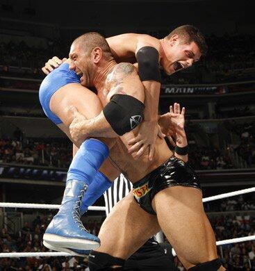 Batista uses his power to dominate World Tag Team Champion Cody Rhodes.