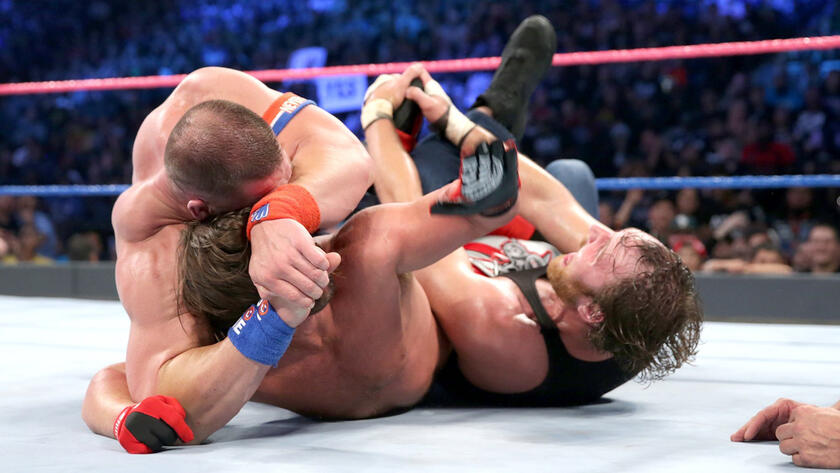 Cena locks in the STF while Ambrose employs the Calf Crusher as Styles endures the excruciating pain. 