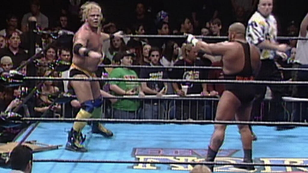 At November To Remember 1998, Taz stands opposite Shane Douglas, pointing in his direction. Douglas has a panicked look on his face.