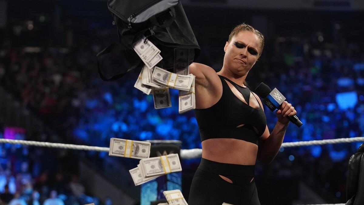 Ronda Rousey pays her fines with bags of money | WWE