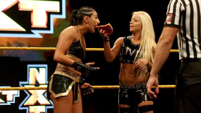 Liv Morgan feeds Daria Berenato a slice of New York pizza